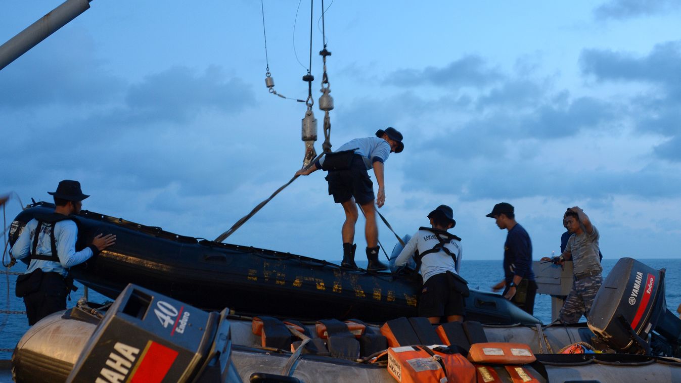 Members of the Indonesian Navy prepare equipment to be lowered into the water from the vessel KRI Banda Aceh to conduct operations to lift the tail of AirAsia flight QZ8501 in the Java Sea on January 9, 2015. Ping signals from the black box data recorders