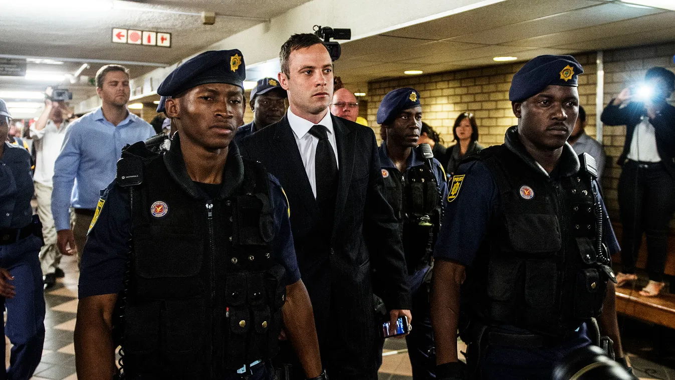South African Paralympic athlete Oscar Pistorius (C) arrives at the High Court in Pretoria on October 21, 2014. Pistorius will finally learn his sentence for shooting dead his girlfriend on Valentine's Day last year, bringing an end to a gripping seven-mo