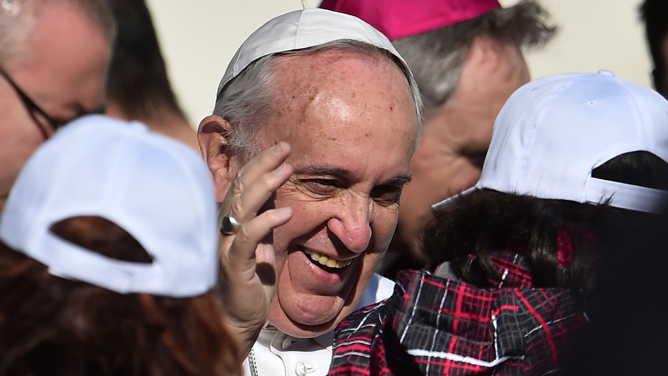 Pope Francis chats with children at the end of his weekly general audience at St Peter's square on February 11, 2015 at the Vatican.  AFP PHOTO / GABRIEL BOUYS 