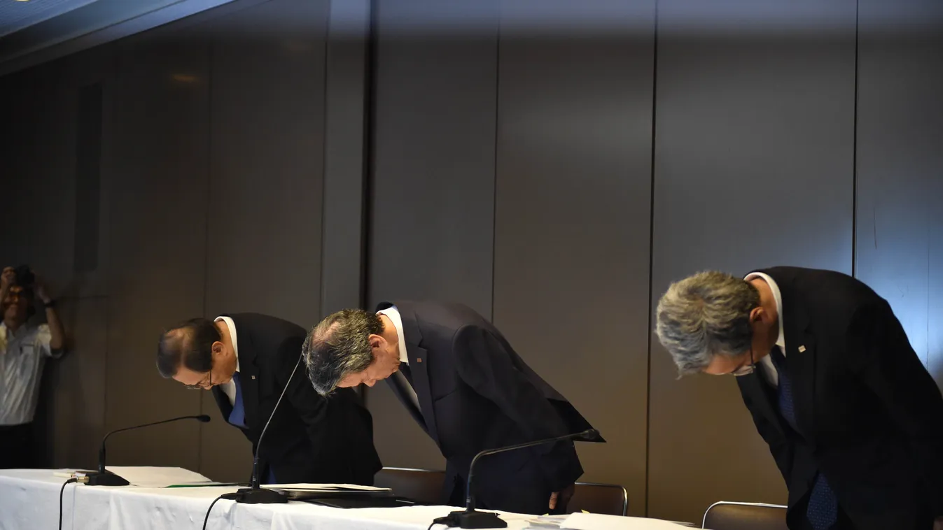 President of Toshiba Hisao Tanaka (C), chairman Masashi Muromachi (L) and corporate executive vice president Keizo Maeda (R) bow at the beginning of a press conference at the company's headquarters in Tokyo on July 21, 2015. Toshiba president Hisao Tanaka