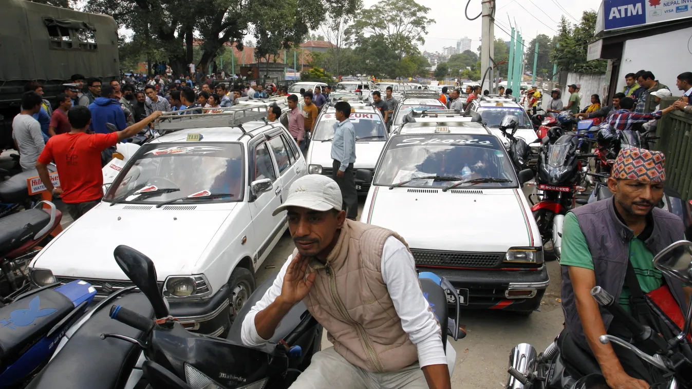 Motorists line up outside a gas station as fuel rations are implemented in Kathmandu on September 28, 2015. Nepal began rationing fuel on September 28 as hundreds of protesters blockaded a key import hub on the Indian border to demand changes to a new con