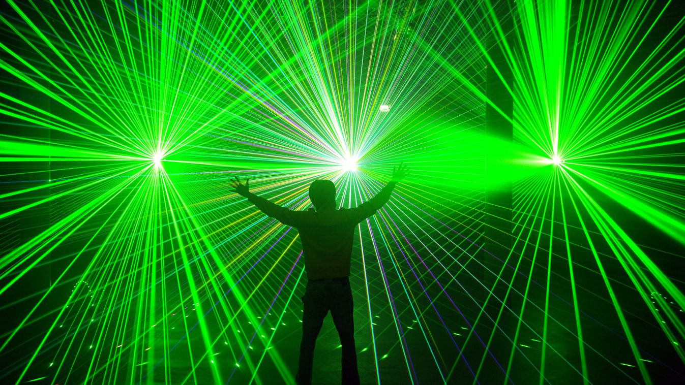 Software engineer and laserlight specialist Andre Daubmann poses amidst of his laser show "LichterMehr" at the Universum Science Center in Bremen, northern Germany, on November 12, 2011. The show is presented at the Center until January 15, 2012. The Univ