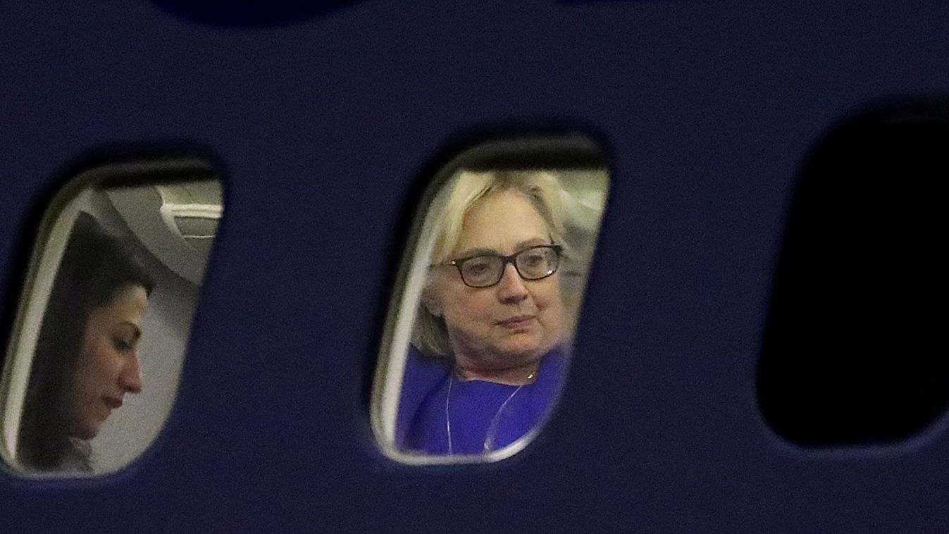 GettyImageRank2 POLITICS ELECTION WHITE PLAINS, NY - SEPTEMBER 08: Democratic presidential nominee former Secretary of State Hillary Clinton (R) and aide Huma Abedin (L) are seen through the windows of the Clinton's campaign plane at Westchester County Ai