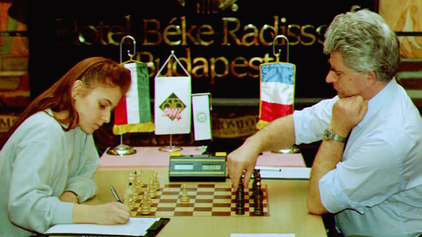 CHESS FLAG MATCH CHAMPION The youngest international chess grand master, 17-year-old Judit Polgar (L) writes down her first move 16 February, 1993 in her last match with Russian born chess champion Boris Spassky (R) in Budapest. The Hungarian girl won the