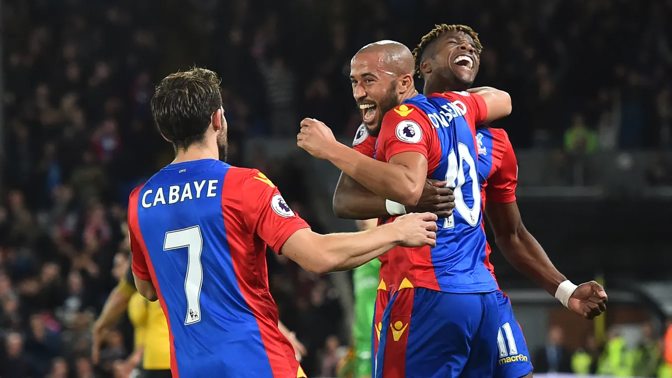 Crystal Palace's English midfielder Andros Townsend celebrates with Crystal Palace's Ivorian striker Wilfried Zaha (R) and Crystal Palace's French midfielder Yohan Cabaye (L) after scoring the opening goal of the English Premier League football match betw