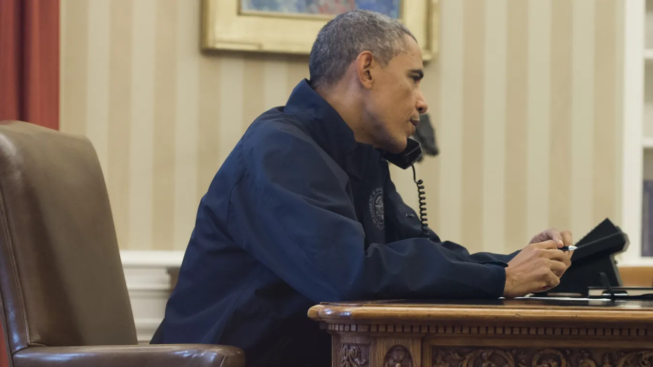 HORIZONTAL PRESIDENT ON THE PHONE SEATED INFORMAL DRESS EPIDEMIC OFFICE US President Barack Obama speaks with Secretary of Health and Human Services Sylvia Burwell from the Oval Office of the White House in Washington, DC, October 12, 2014. The President 