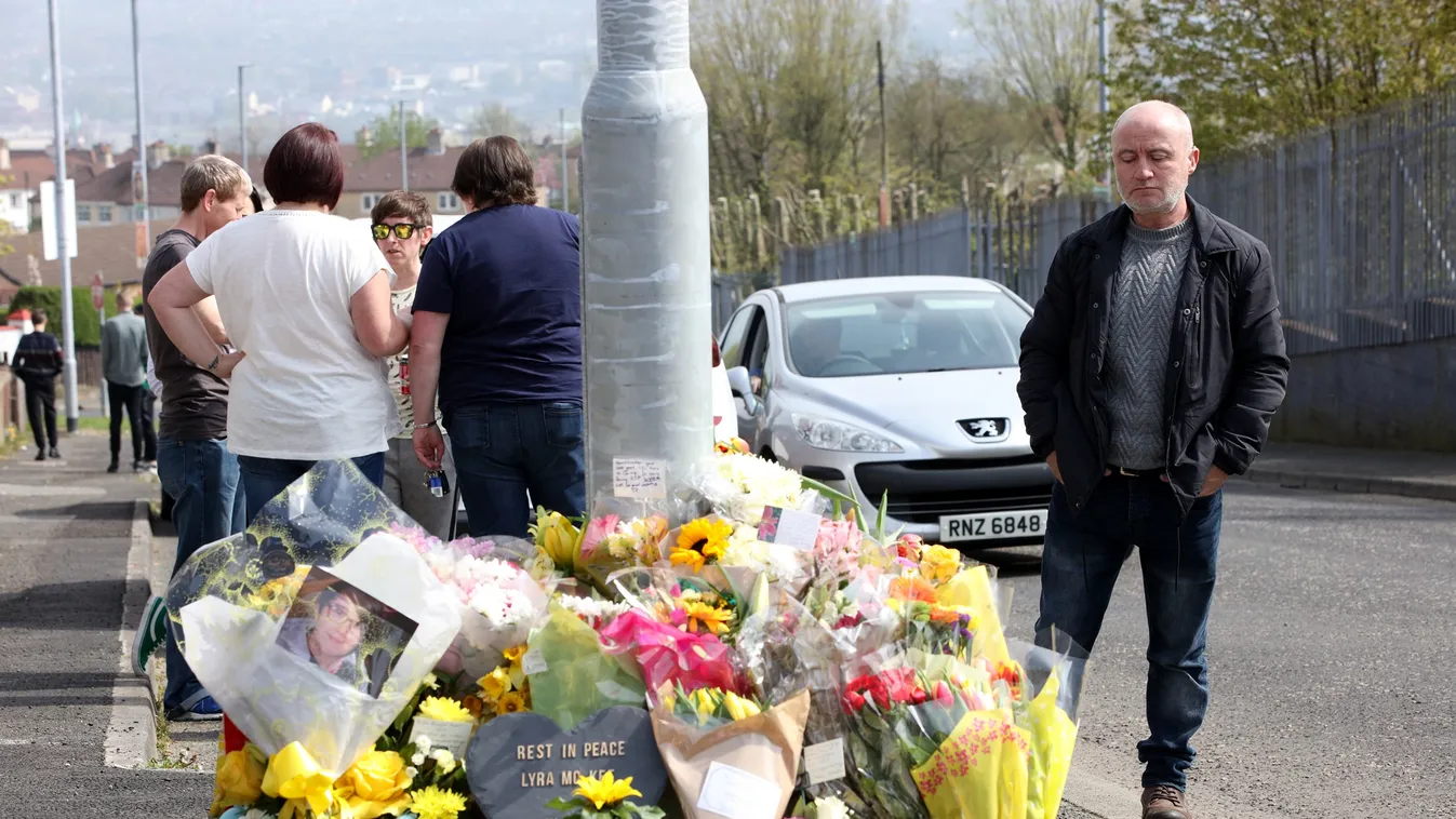 conflict Horizontal (FILES) In this file photo taken on April 20, 2019 People gather around the floral tributes placed at the scene in the Creggan area of Derry (Londonderry) in Northern Ireland on April 20, 2019 where journalist Lyra McKee was fatally sh