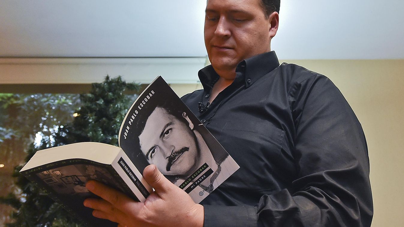 Juan Pablo Escobar, son of Colombian drug kingpin Pablo Escobar, reads the book he wrote about his father, during an interview with AFP in Bogota on November 7, 2014. The Medellin cartel founder, Escobar, was famed for some of the bloodiest, most ruthless