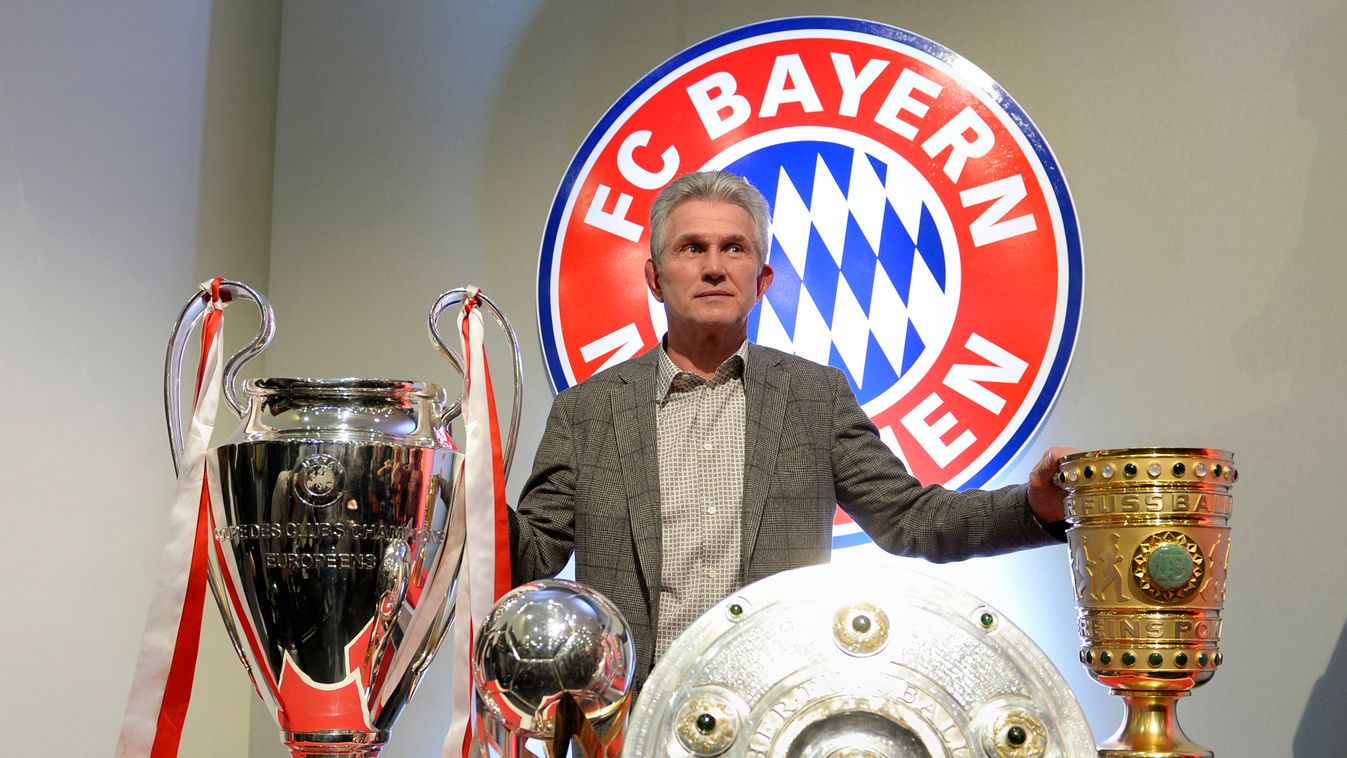 HORIZONTAL Bayern Munich's head coach Jupp Heynckes poses with four trophy's after giving his farewell press conference in Munich, southern Germany, on June 4, 2013. Heynckes spoke about his future after he won with his team the UEFA Champions League, the