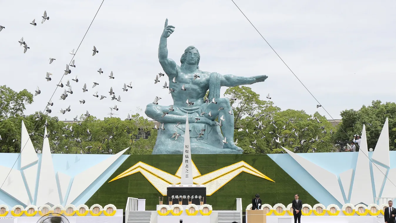war history nuclear Horizontal Doves fly around the Peace Statue during a memorial service to mark the 74th anniversary of the atomic bombing at the Peace Memorial Park in Nagasaki on August 9, 2019. (Photo by JIJI PRESS / JIJI PRESS / AFP) / Japan OUT 