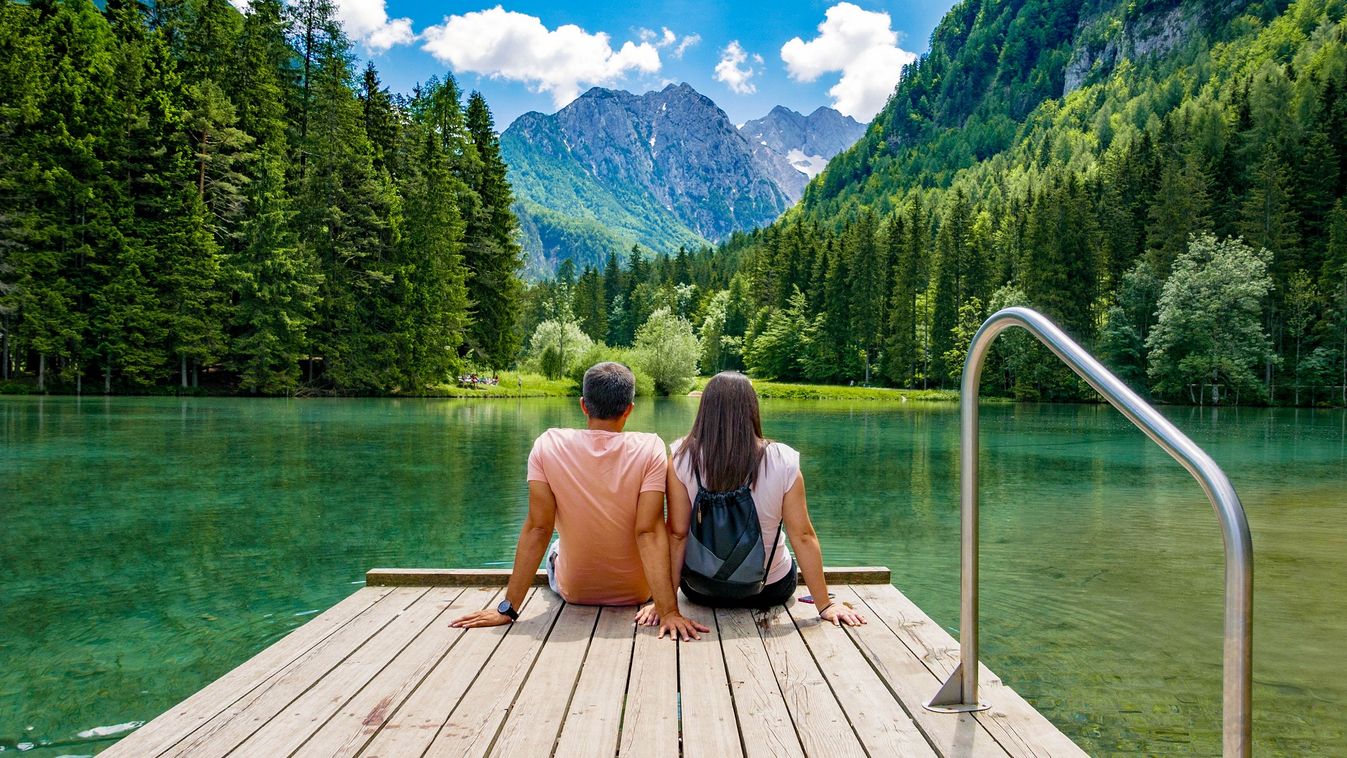 Rear,View,Of,Young,Female,Sitting,On,Wooden,Deck,By love,couple,forest,mountains,alps,friendship,young,deck,togetherness,tourism,exploringnature,scenic,holiday,szlovénia, nyár 