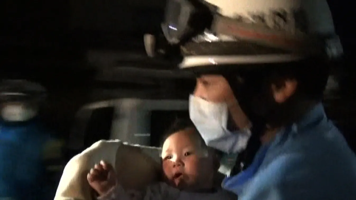 earthquake TOPSHOTS Horizontal This handout image taken from video footage released by the Kumamoto Prefectural Police on April 15, 2016 shows a rescue worker carrying an eight-month-old baby girl after she was pulled from the rubble following an earthqua