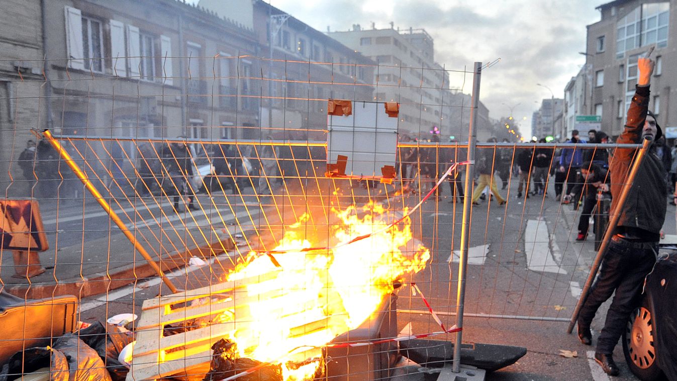 Garbage are set on fire on November 22, 2014 in Toulouse, southwestern France, during a protest against police brutality following the death of 21-year-old Remi Fraisse, who died during violent clashes between security forces and protesters against the pr