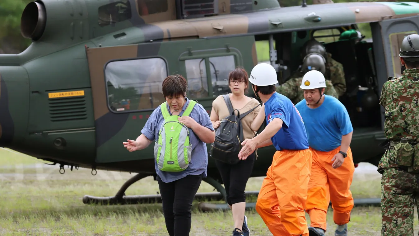 flood weather Horizontal Flood affected residents from an isolated village disembark a Japan Self Defense Force helicopter in Hitoyoshi, Kumamoto prefecture on July 7, 2020. - Emergency services in western Japan were "racing against time" on July 7 to res