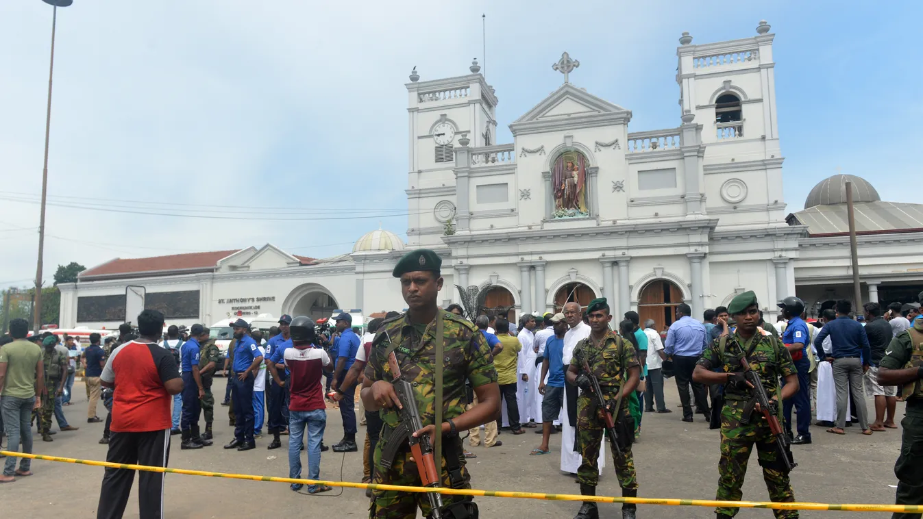 Horizontal Sri Lankan security personnel keep watch outside the church premises following a blast at the St. Anthony's Shrine in Kochchikade, Colombo on April 21, 2019. - Explosions have hit three churches and three hotels in and around the Sri Lankan cap