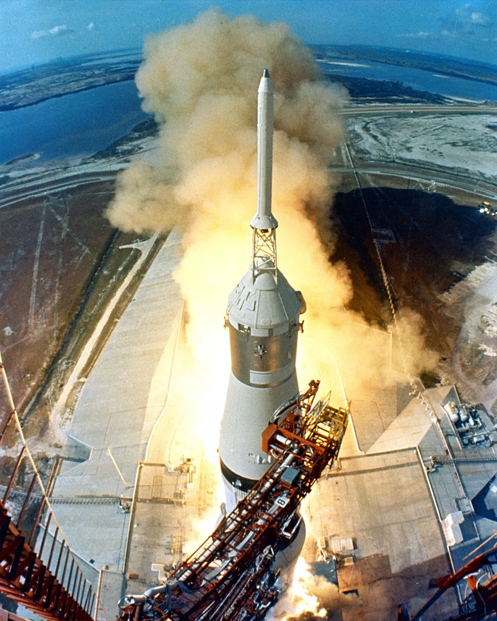 Apollo 11 Saturn V Launch At 9:32 a.m. EDT, the swing arms move away and a plume of flame signals the liftoff of the Apollo 11 Saturn V space vehicle and astronauts Neil A. Armstrong, Michael Collins and Edwin E. Aldrin, Jr. from Kennedy Space Center Laun