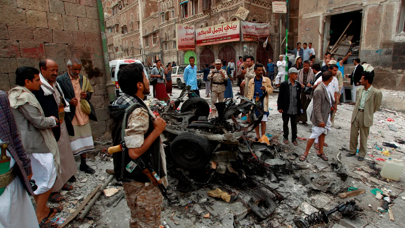 Yemenis surround the wreckage of a vehicle outside the Kobbat al-Mehdi Shiite mosque in the capital Sanaa on June 20, 2015, after a car bomb targeting the area killed two people. The explosion in Sanaa, controlled by Iran-backed Shiite Huthi rebels, went 
