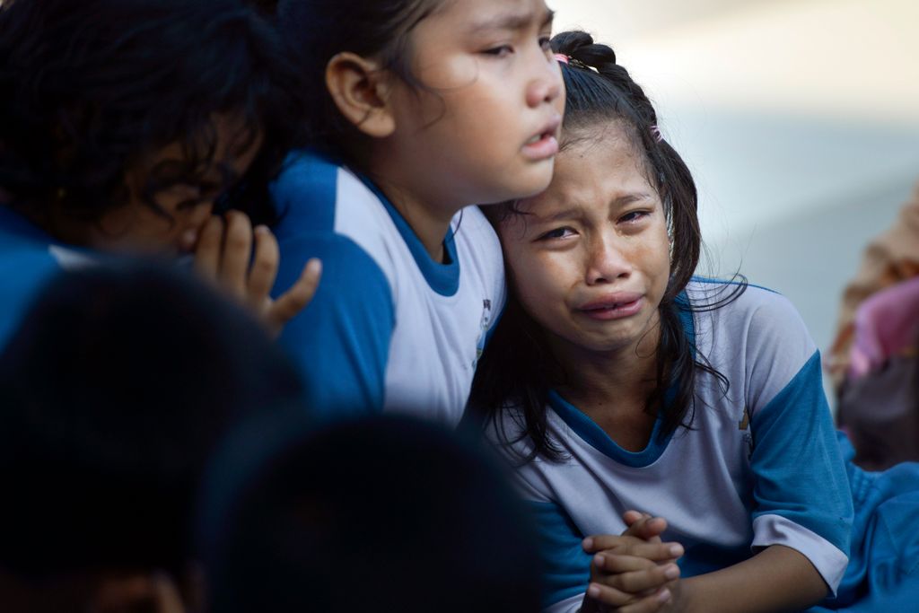 Horizontal PREVENTATIVE MEASURE NATURAL DISASTERS TRAINING CHILD SCHOOLCHILD EMERGENCY EXERCISE LITTLE GIRL IN TEARS AFRAID Indonesian students cry while taking part take part in an earthquake and tsunami drill in Banda Aceh on December 1, 2018. - On Dece
