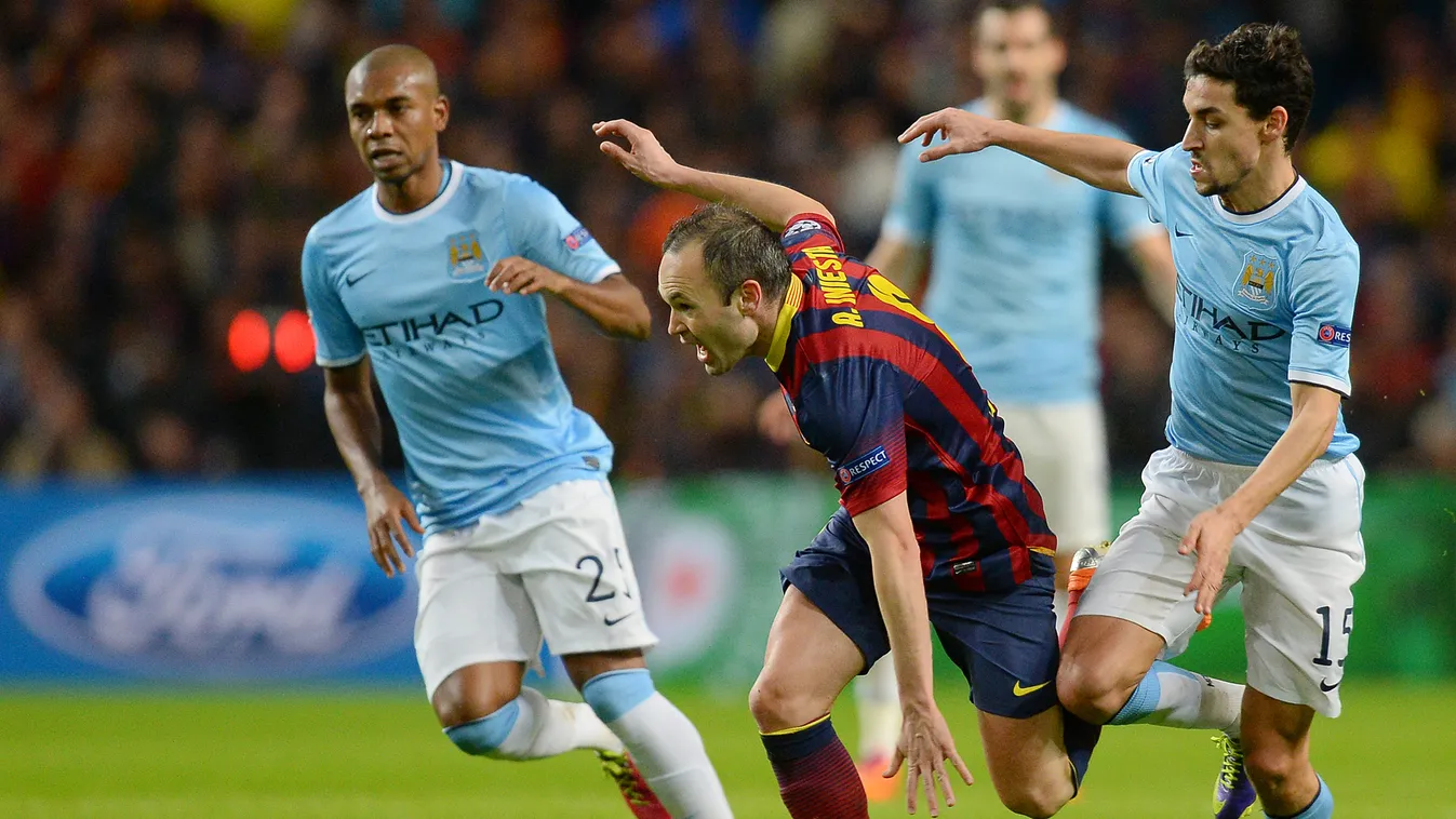 463411521 Barcelona's midfielder Andres Iniesta (2nd L) looks for a way through during the UEFA Champions League Last 16, first leg football match between Manchester City and Barcelona at The Etihad Stadium in Manchester, northwest England on February 18,