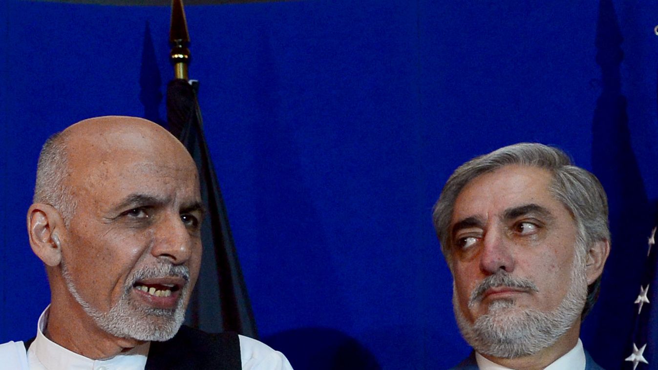 (FILES) In this photograph taken on August 8, 2014, Afghan presidential candidate Ashraf Ghani (L) speaks as opponent Abdullah Abdullah looks on during a joint press conference with unseen US Secretary of State John Kerry at the United Nations Compound in