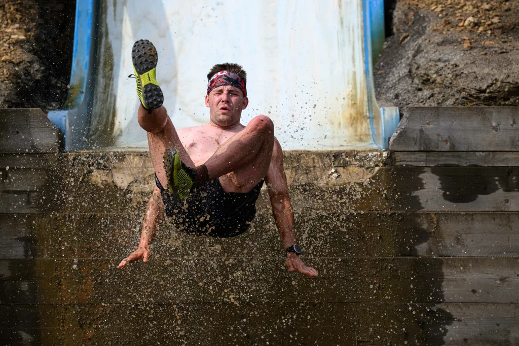 Horizontal OFFBEAT SPORTS EVENT MUD RACE GAMES AND RECREATION A competitor takes part in the Bog Commander endurance event near Ashbourne, in the Peak District moorlands, in northern England, on May 14, 2022. - The Bog Commander is a muddy obstacle race o