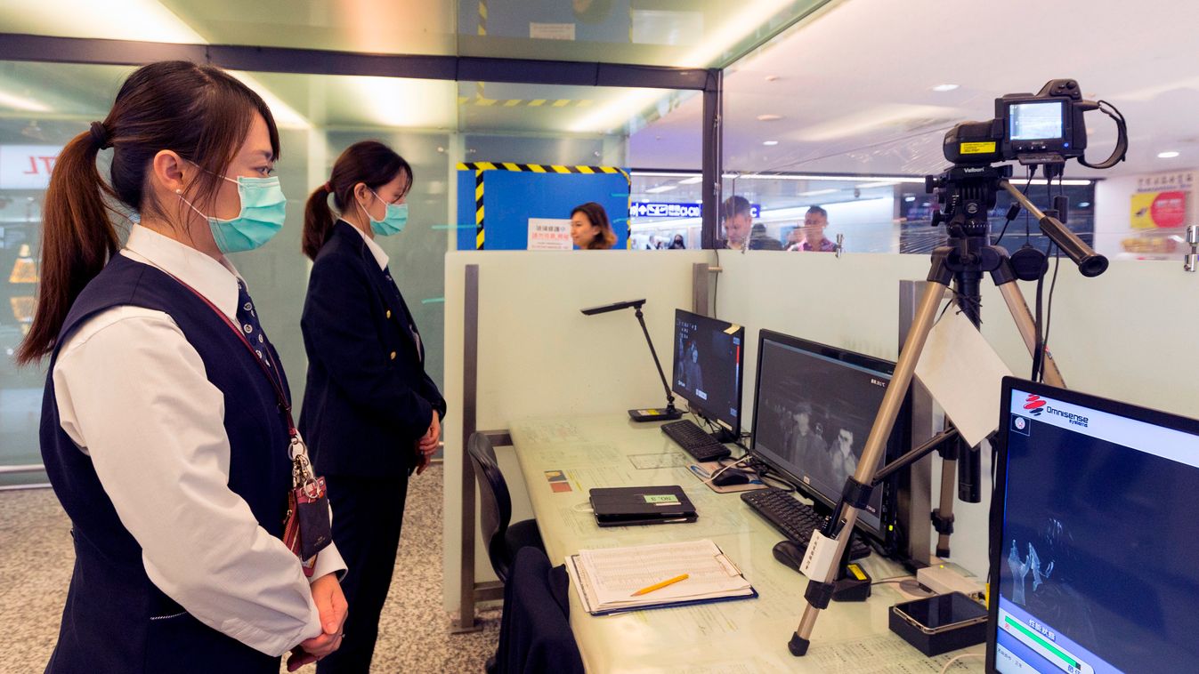 Disease virus epidemic TOPSHOTS Horizontal This picture taken on January 13, 2020 shows Taiwan's Center for Disease Control (CDC) personnel using thermal scanners to screen passengers arriving on a flight from China's Wuhan province, where a SARS-like vir