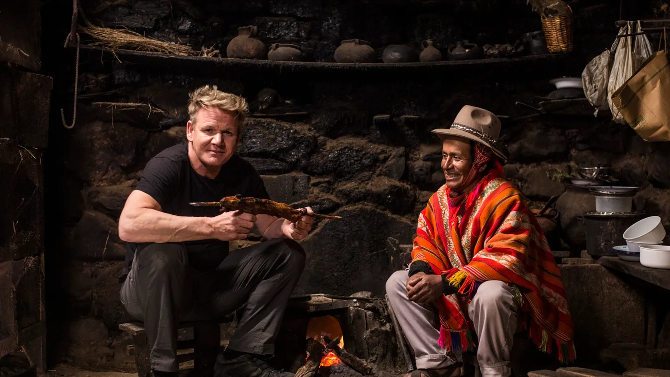 81140 Peru - Gordon Ramsay (L), holding a cooked Guinea pig, visits with Mario, a local farmer in Peru. (National Geographic/Ernesto Benavides) 