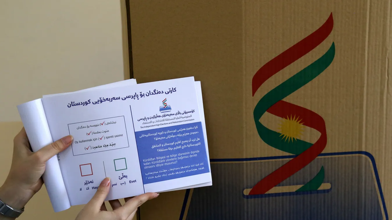voting politics referenda Horizontal An employee from the Independent High Electoral Referendum Commission holds a voting ballot book at a voting station ahead of tomorrow's planned referendum for the Kurdistan region, in Arbil, the capital of the autonom