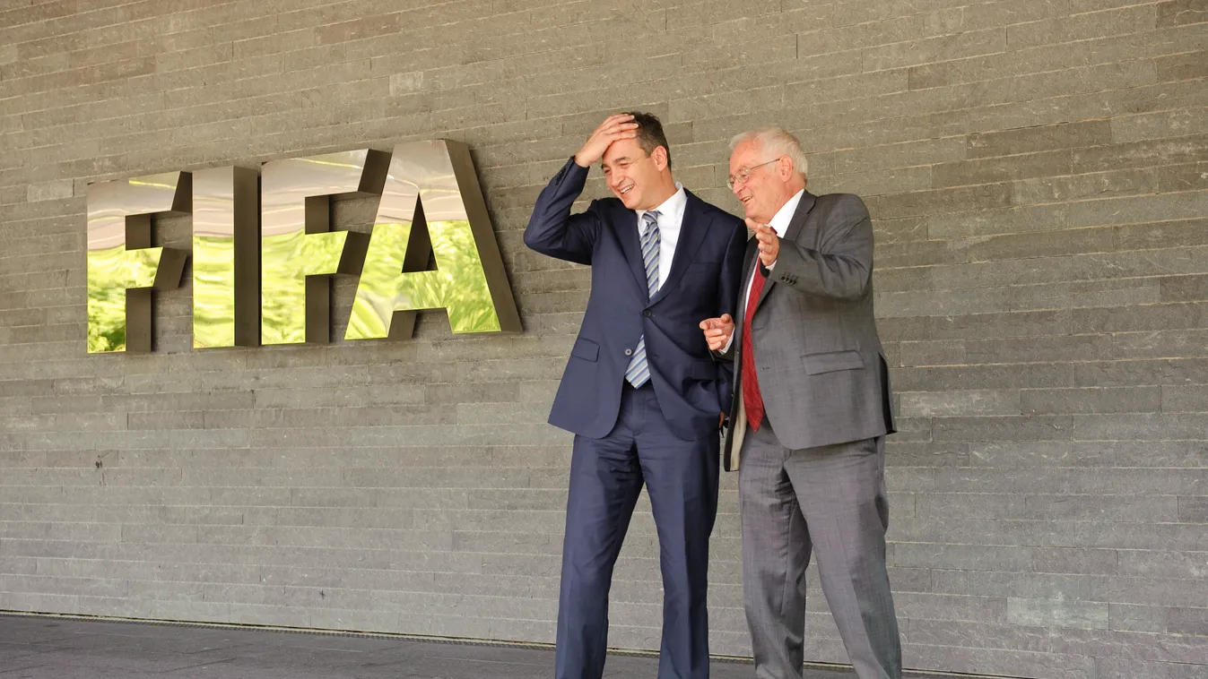 Michael J Garcia (C), Chairman of the investigatory chamber of the FIFA Ethics Committee, and Hans-Joachim Eckert (R), Chairman of the adjudicatory chamber of the FIFA Ethics Committee, pose for photographers at the end of a press conference at the FIFA's