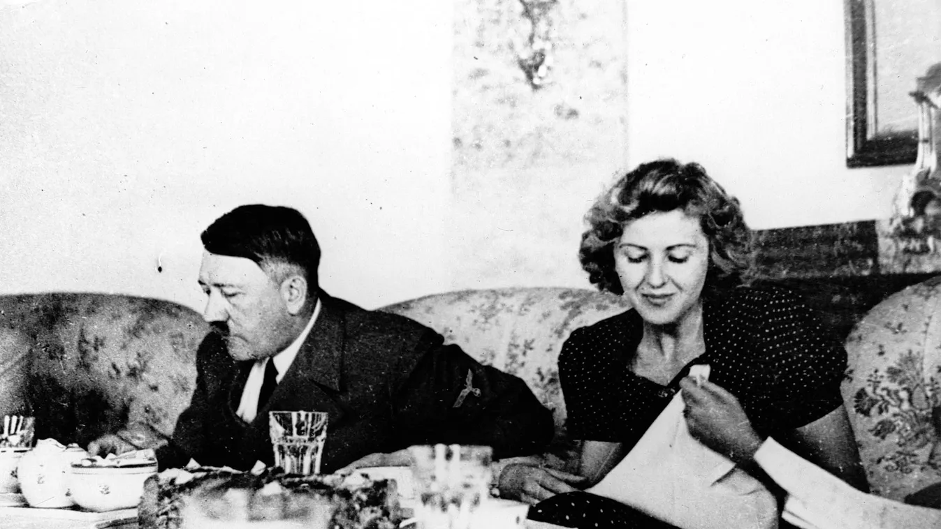 FILE - This undated file picture shows the German Fuehrer Adolf Hitler and his mistress Eva Braun while dining. A German woman named Margot Woelk was one of 15 young women who sampled Hitler's food to make sure it wasn’t poisoned before it was served to t