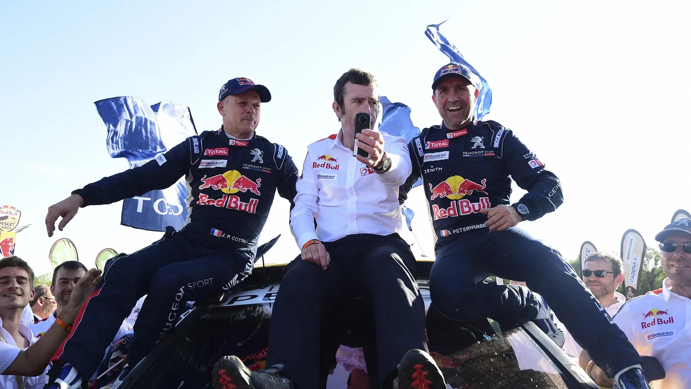 (from L to R) Peugeot's co-driver Jean Paul Cottret of France, team manager Bruno Famin and driver Stephane Peterhansel celebrate their victory at the end of the Stage 12 of the Dakar 2017 between Rio Cuarto and Buenos Aires, Argentina, on January 14, 201