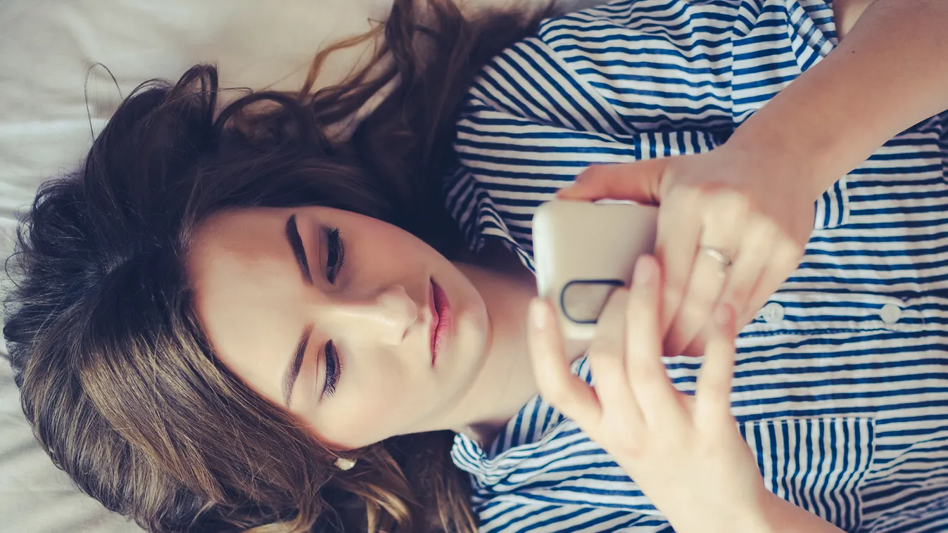 Closeup,Of,Sad,Teenage,Girl,Lying,In,Bed,Using,Her smartphone,bad,caucasian,sadness,youth,beautiful,disappointed,wh Closeup of sad teenage girl lying in bed using her mobile. Young pretty woman with bored expression looking at message on her cell phone, r