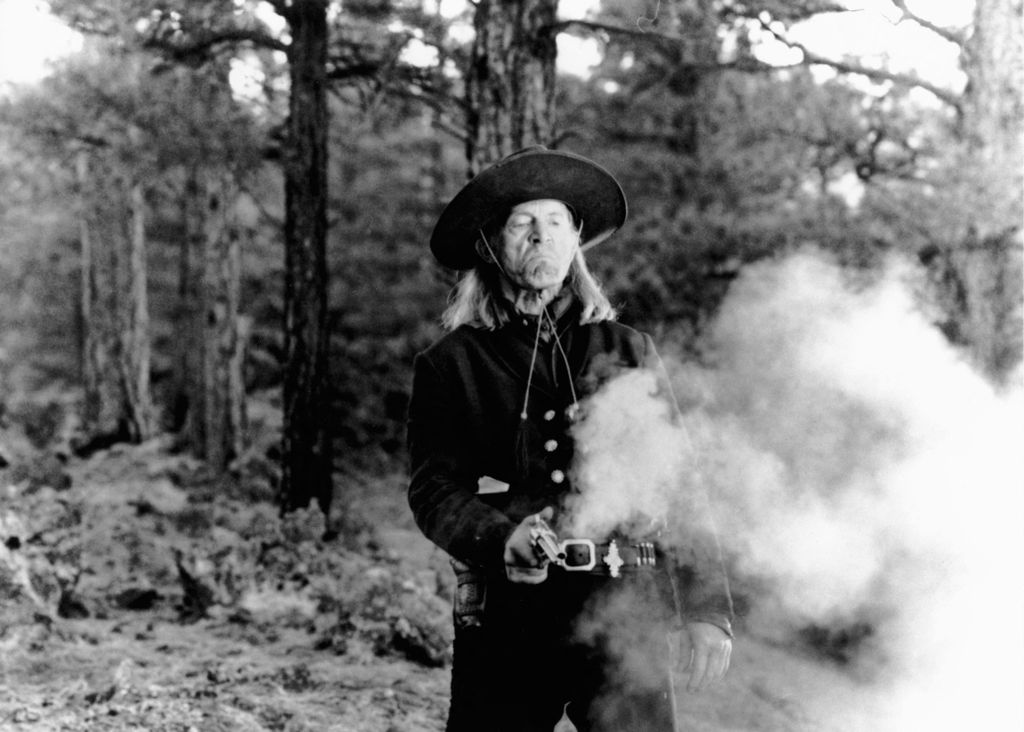 Dead Man Cinema revisionist western 19th century fantasy pistol to shoot Horizontal MAN HAT WEAPON SMOKE 
