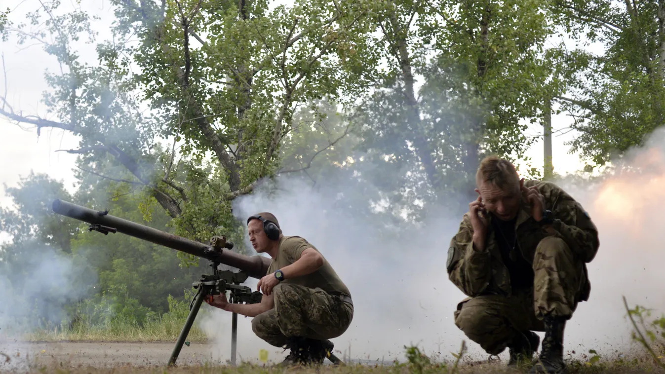 TOPSHOTS
Ukrainian servicemen shout from SPG-9 antitank grenade launcher during the combat with the pro-Russian separatists near Avdeevka, Donetsk region, on June 18, 2015. Russian President Vladimir Putin said his country was open to the world and would 