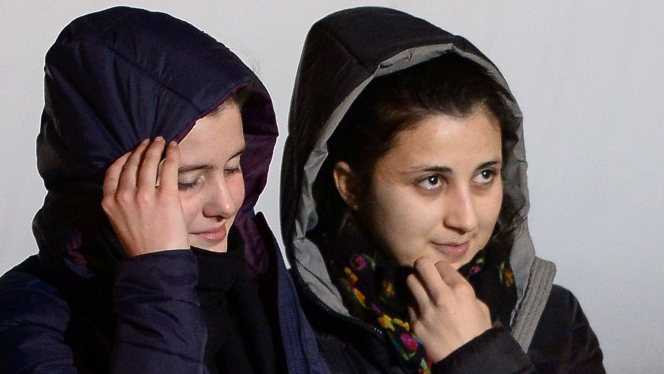 Italian aid workers abducted in Syria last summer, Greta Ramelli (L) and Vanessa Marzullo disembark from a plane early on January 16, 2015 at Ciampino airport in Rome after being freed yesterday. Officials did not release any further details of how the tw