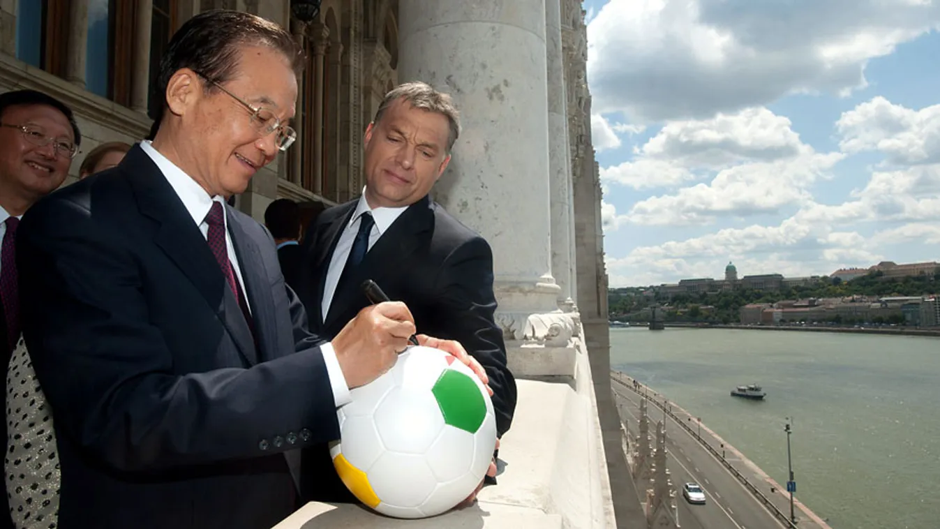 keleti nyitás,  Ven Csia-pao (Wen Jiabao) kínai kormányfő (b) aláír egy ajándék futball-labdát Orbán Viktor miniszterelnök (j) számára az Országház erkélyén