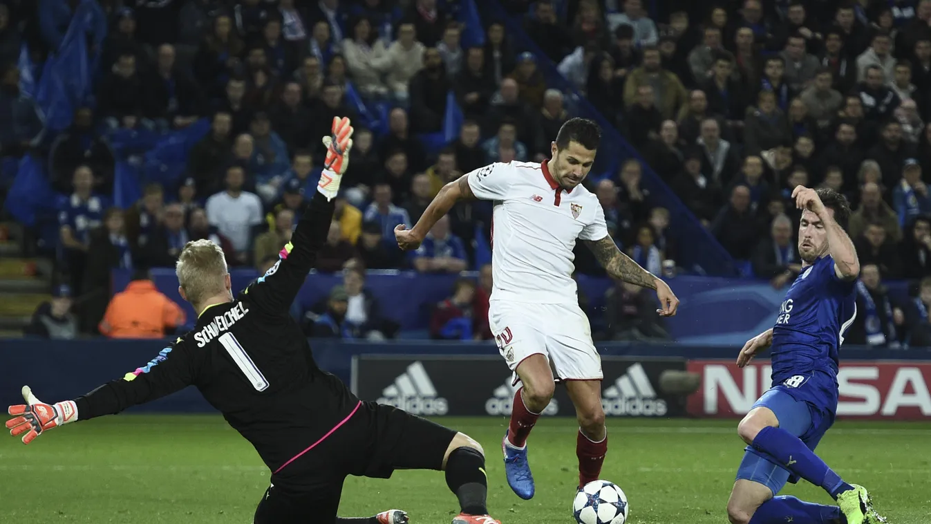 Leicester City's Danish goalkeeper Kasper Schmeichel (L) brings down Sevilla's midfielder Vitolo (C) in the area to concede a penalty during the UEFA Champions League round of 16 second leg football match between Leicester City and Sevilla at the King Pow