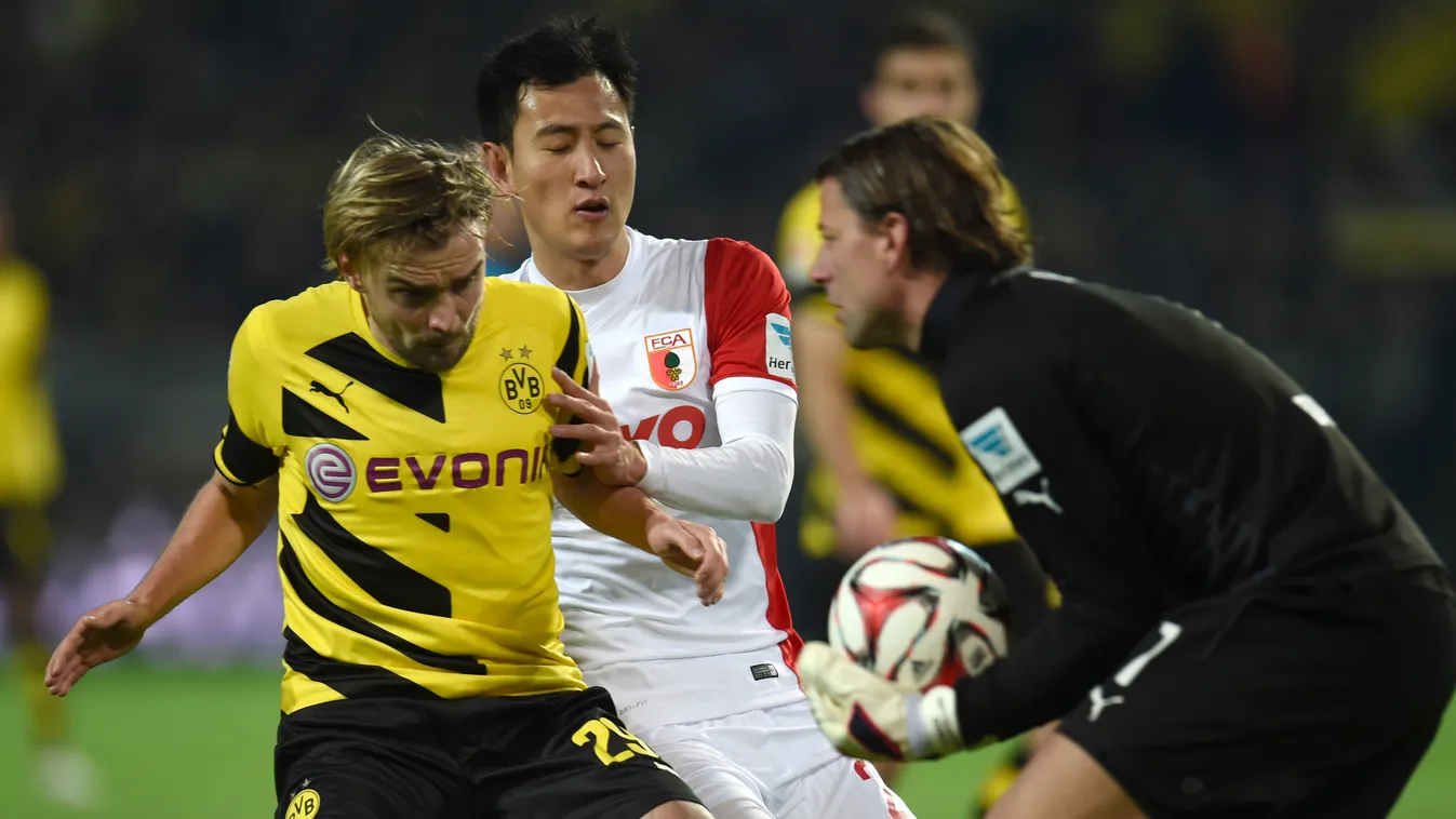 504671359 Augsburg's South Korean forward Dong-Won Ji (C), Dortmund's defender Marcel Schmelzer (L) and Dortmund's goalkeeper Roman Weidenfeller vie for the ball during the German first division Bundesliga football match Borussia Dortmund vs FC Augsburg i