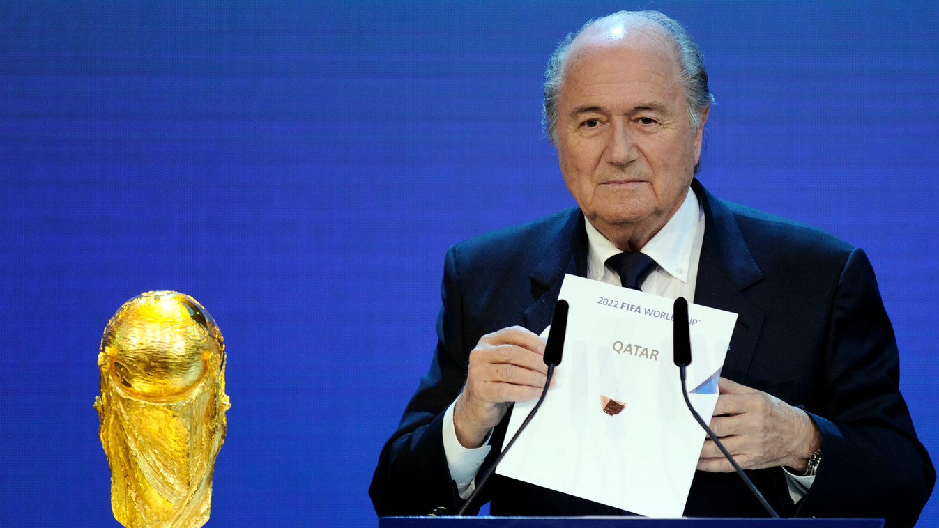 HORIZONTAL (FILES) A file picture taken on December 2, 2010 shows FIFA President Sepp Blatter holding up the name of Qatar during the official announcement of the 2022 World Cup host country at the FIFA headquarters  in Zurich. Football's world governing 