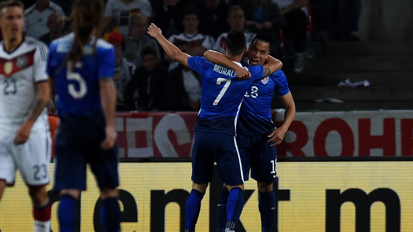 US Alfredo Morales and Bobby Wood celebrate during the International friendly football match between Germany and the USA in Cologne, western Germany on June10, 2015. The USA won the match 1-2. AFP PHOTO / PATRIK STOLLARZ 