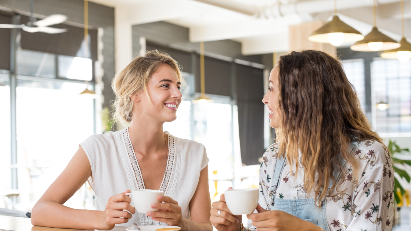 Women talking over coffee Beautiful Serene People Toothy Smile Morning Only Women Girls Young Women Women Two People Coffee Shop Espresso Cappuccino Cafeteria 20-29 Years Young Adult Smiling Asking Explaining Talking Drinking Gossip Fun Beauty Mixed Race 