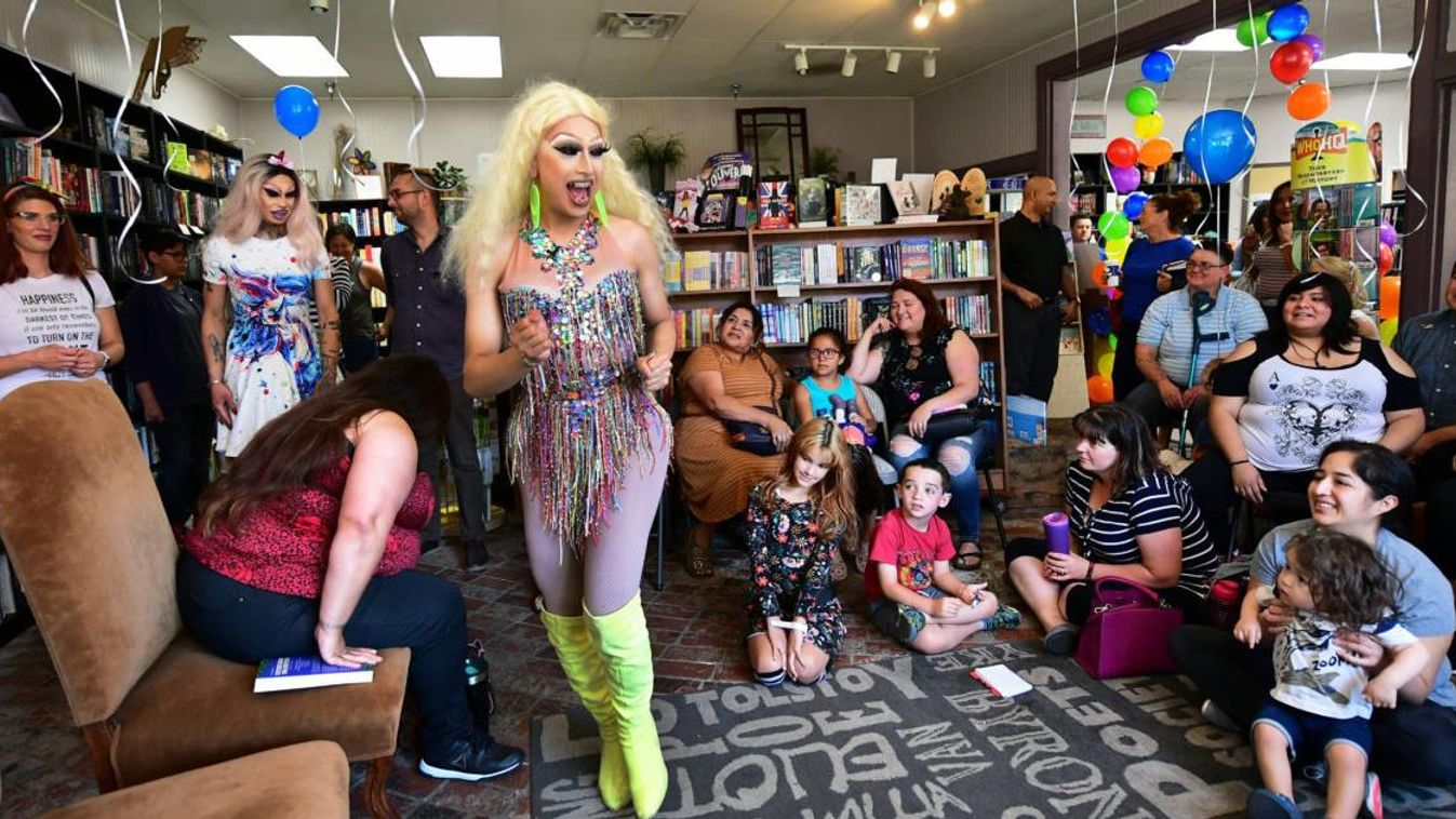 US-LIFESTYLE-GAY-RIGHTS-GENDER-SOCIETY-BOOKS gender homosexuality rights Horizontal Drag queens Athena Kills (C) and Scalene Onixxx arrive to awaiting adults and children for Drag Queen Story Hour at Cellar Door Books in Riverside, California on June 22, 