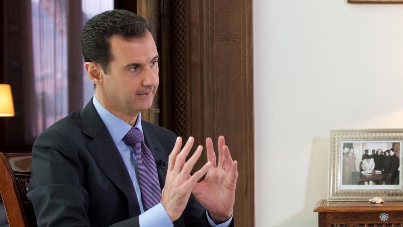 Horizontal panoramic A handout picture released by the official Syrian Arab News Agency (SANA) on December 6, 2015 shows Syrian President Bashar al-Assad (L) giving an interview to a journalist from the Britain's Sunday Times in his Damascus residence. AF