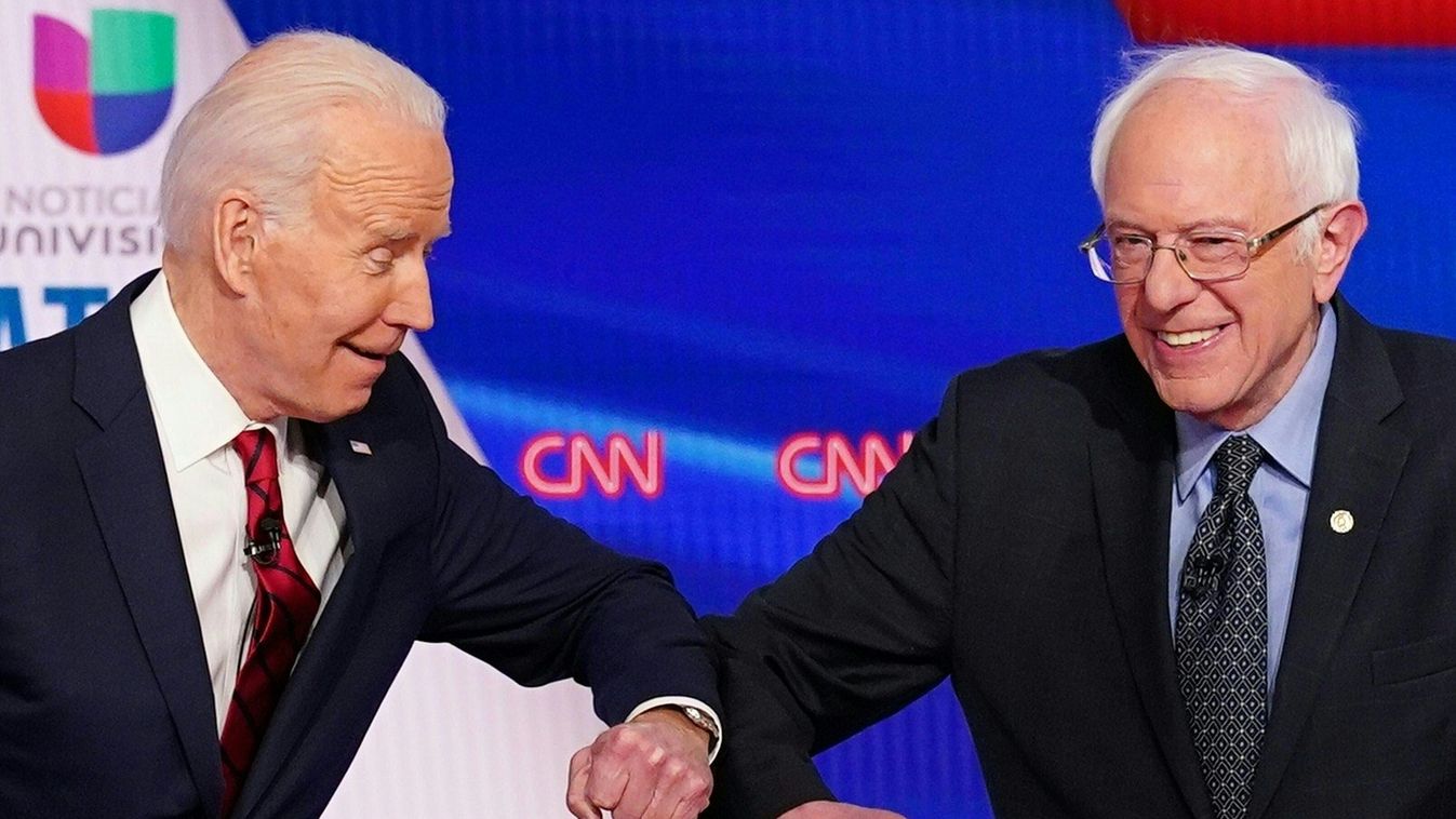 TOPSHOTS Horizontal TELEVISED DEBATE POLITICAL CAMPAIGN Democratic presidential hopefuls former US vice president Joe Biden (L) and Senator Bernie Sanders greet each other with a safe elbow bump before the start of the 11th Democratic Party 2020 president