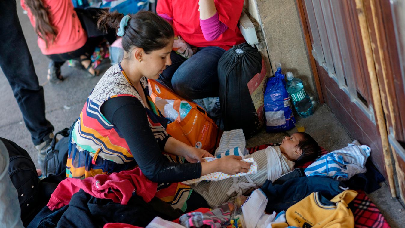 Migrant woman takes care of a baby at Vienna's Westbahnhof train station in Vienna, Austria, on September 6, 2015 after refugees arrived by a train from Hungary.Thousands of migrants and refugees has transited via Vienna where the were welcomed and helped