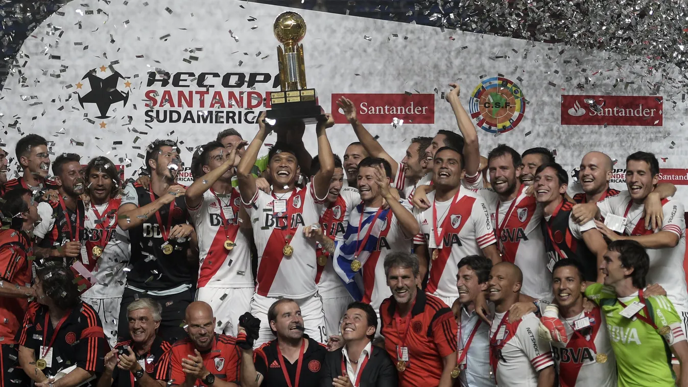 River Plate's forward Teofilo Gutierrez (C) lifts the Recopa Sudamericana 2015 trophy surrounded by teammates after defeating San Lorenzo 1-0 in their second final football match at Pedro Bidegain stadium in Buenos Aires, Argentina, on February 11, 2015. 