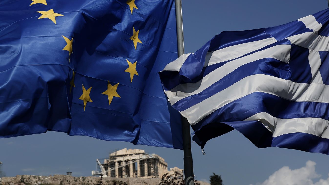 An EU and a Greek flag fly in front of the ancient Parthenon temple, in Athens, Greece görög 