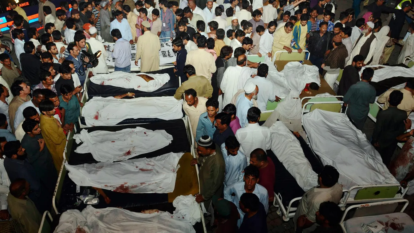 Pakistani relatives gather around the bodies of blast victims after a suicide bomb attack near the Wagah border on November 2, 2014. A suicide bomber killed at least 45 people November 2 at the main Pakistan-India border crossing, the blast tearing throug