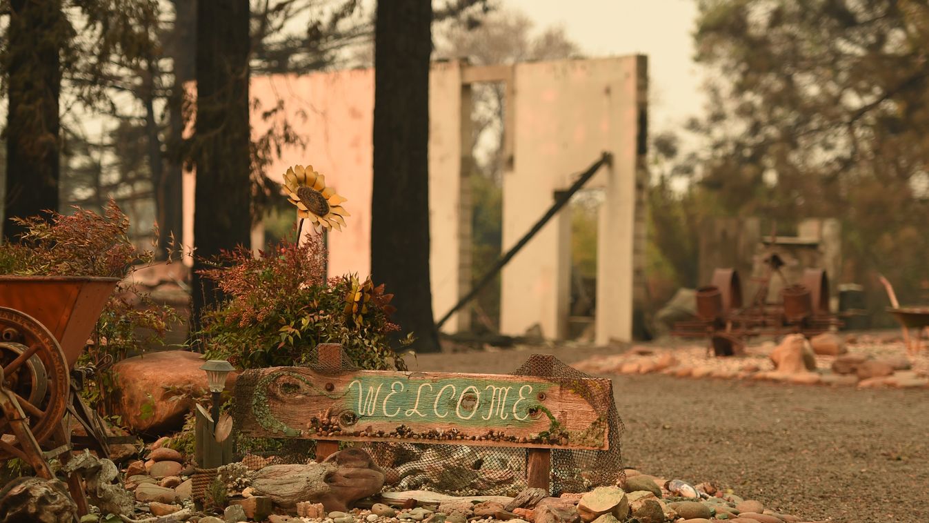 fire accident Horizontal A welcome sign remains near a burned residence after the Camp fire tore through the region in Paradise, California on November 12, 2018. - Thousands of firefighters spent a fifth day digging battle lines to contain California's wo