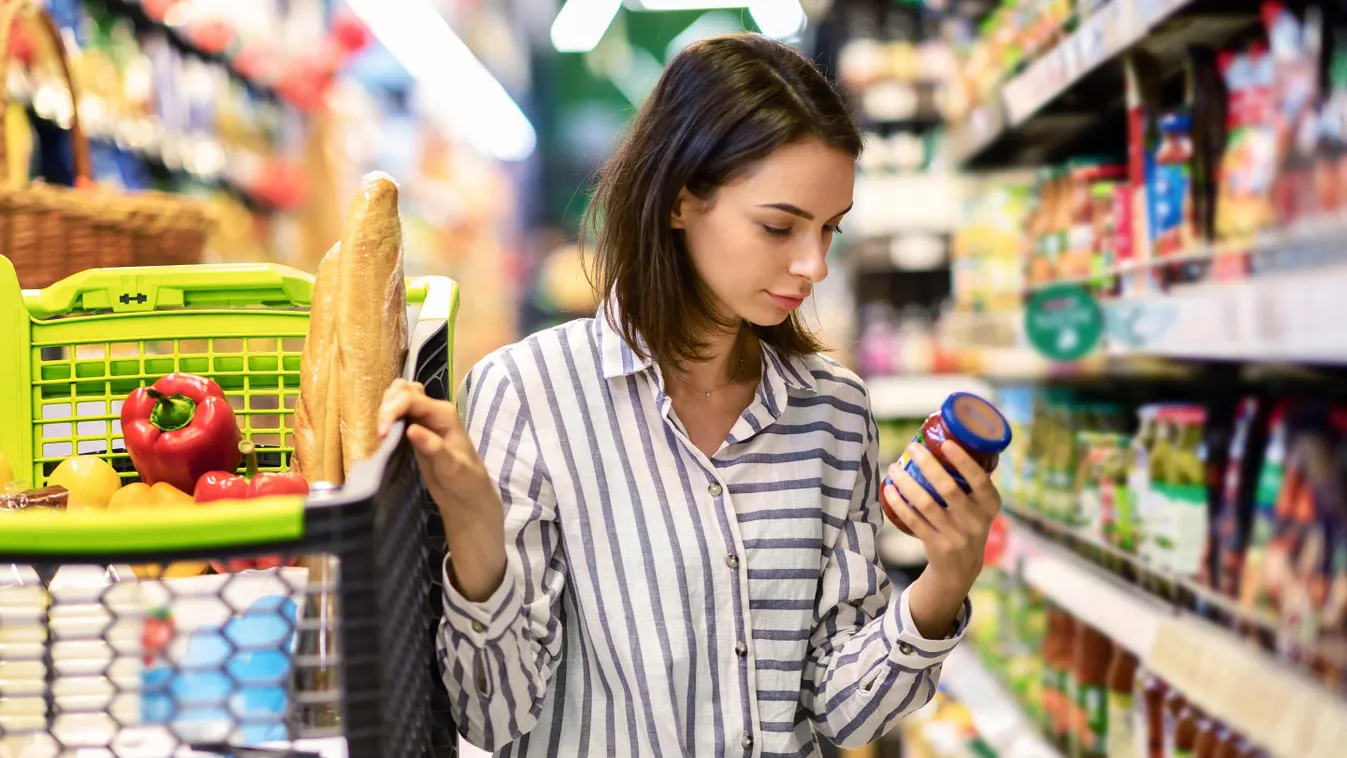 Young woman with the cart shopping in hypermarket woman supermarket grocery food retail shopper shopping store shelf cheerful customer consumerism healthy market young mall choice cart lifestyle shop basket sale buyer purchase organic hypermarket trolley 